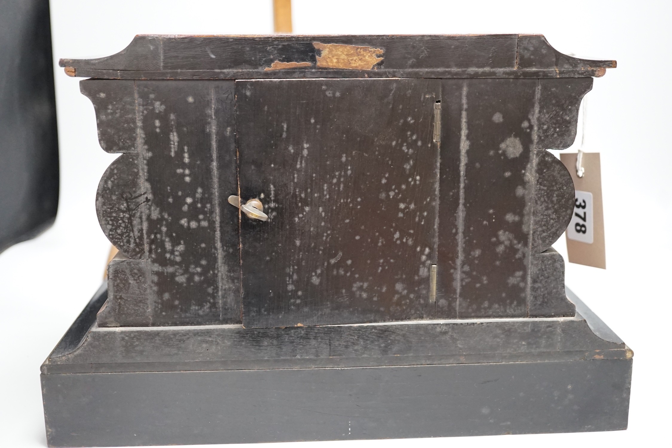A Victorian walnut and ebonised bracket clock with two classical cartouches, 33cms wide x 23cms high not including bracket